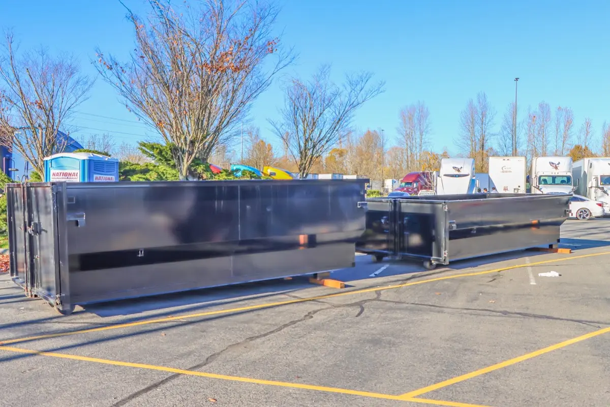 Professional dumpster rental service with roll-off container on residential driveway in Gardner